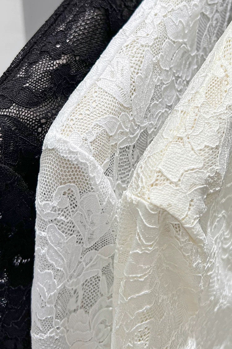 Close-up of black, white, and gray lace fabric.