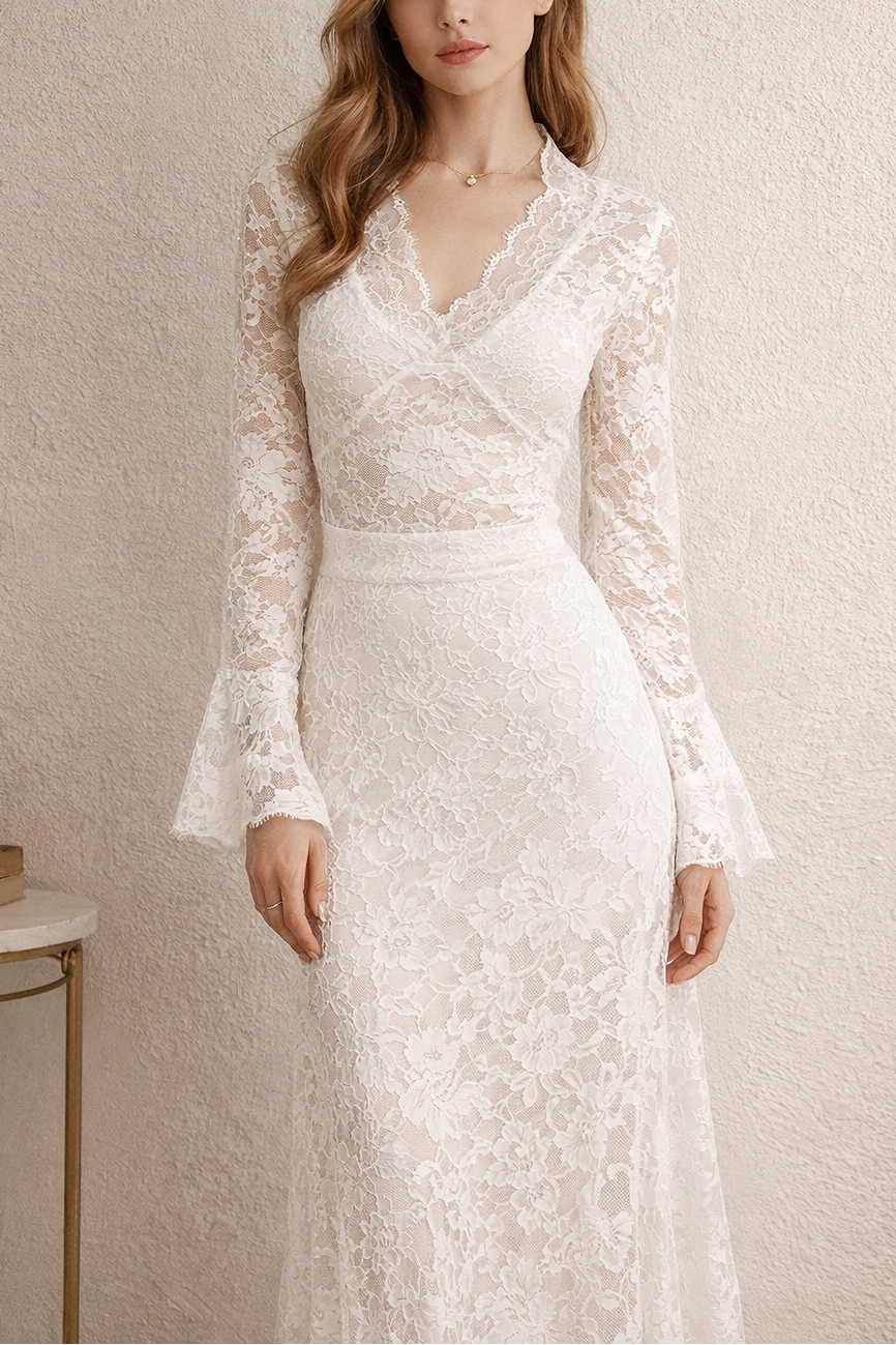 Woman wearing a lace wedding dress with long sleeves against a neutral background