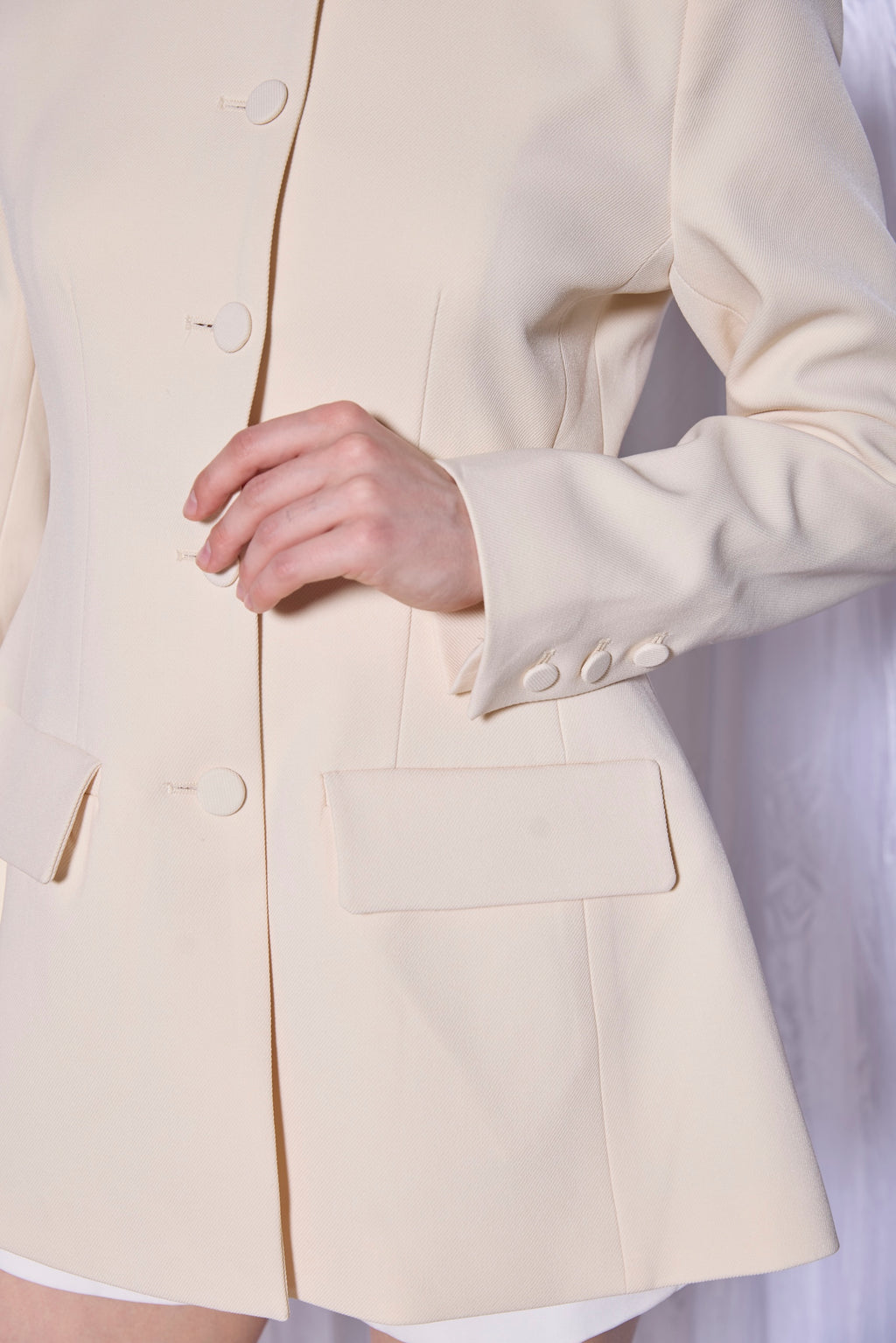 Close-up of a beige blazer with a blurred background