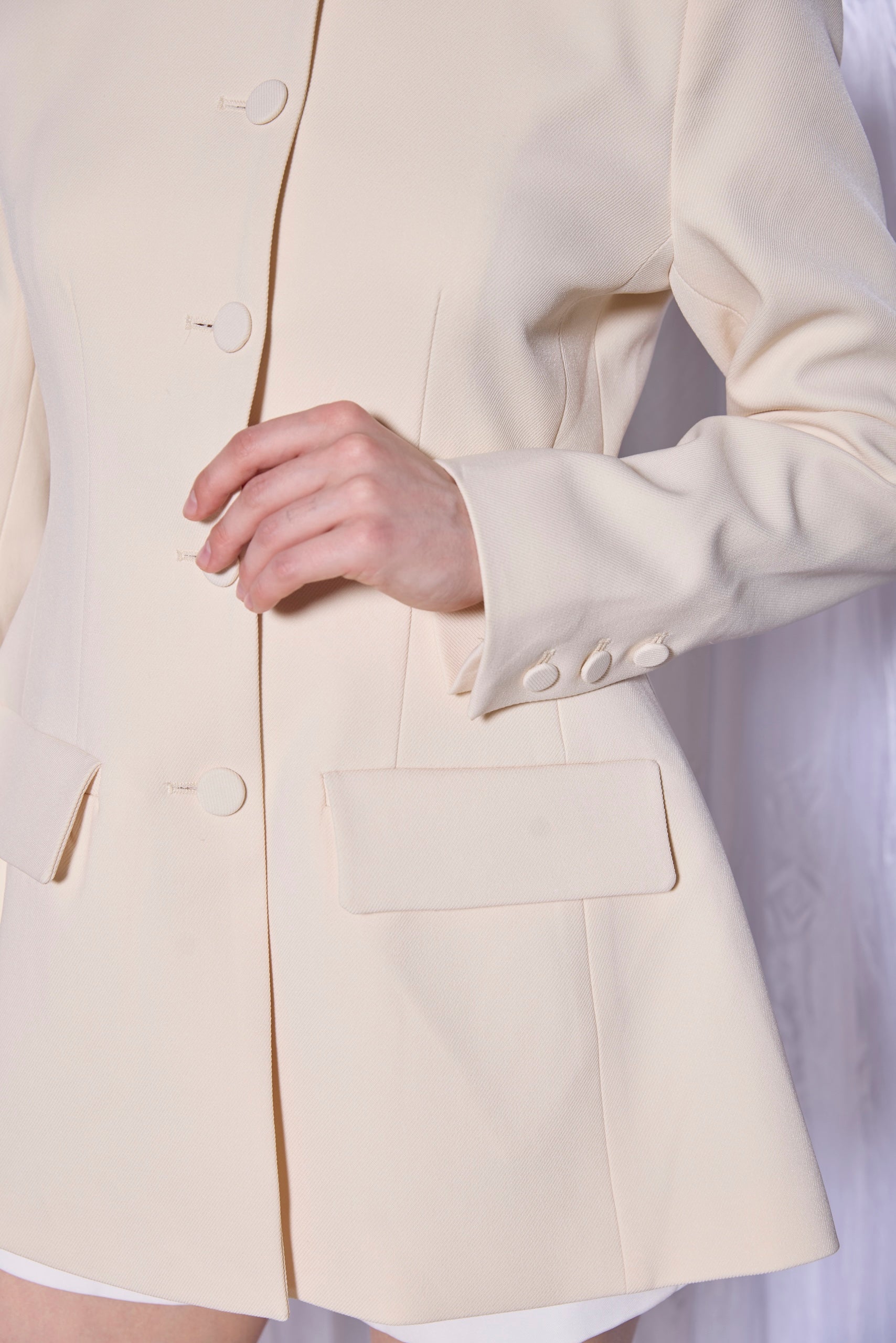 Close-up of a beige blazer with a blurred background