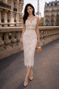 Woman in a lace dress standing on a street with a blurred background